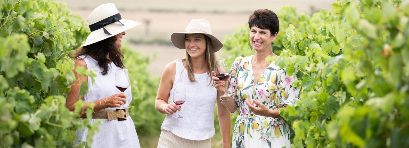 Women enjoying Tumblong Hills wine in the vineyard